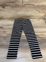 Black and white striped kids leggings on wood floor, children's resale clothing.