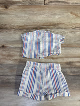 Flat-lay of Cat & Jack newborn striped button-up shirt and elastic-waist shorts set showing blue and red stripes on cream fabric