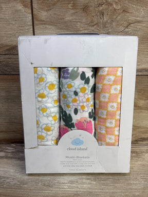 Front view of Cloud Island 3-pack muslin swaddle blankets showing three floral and geometric prints in a white display box on a wooden surface