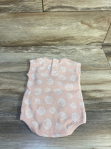 Flat lay back view of Easy Peasy tank bodysuit in peach powder with white polka dots and back buttons on wood floor