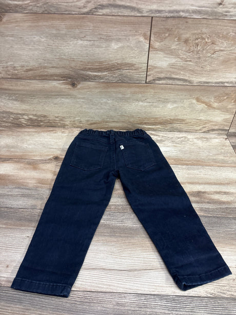 Back view of Easy Peasy dark wash navy blue jeans for toddlers, size 3T, on a wood background.