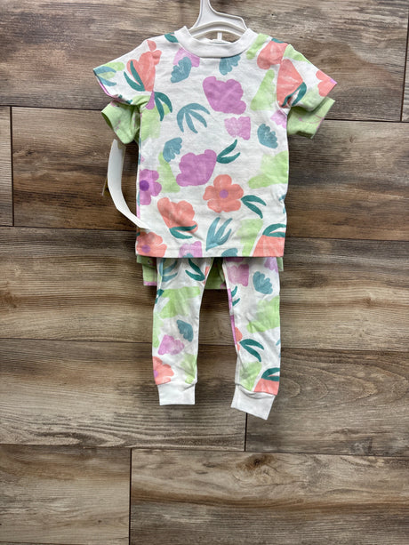 Back view of Just One You 4-piece baby pajama set showing pastel floral print top and matching leggings on wood background