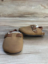 Brown baby shoes with buckles on wood background, soft sole infant footwear