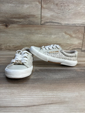 Michael Kors kids sneakers with gold logo, white laces, and patterned design on wooden floor