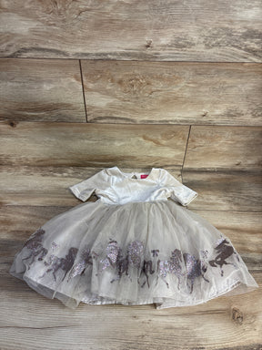 White velvet toddler dress with tulle skirt featuring glittery running horse pattern on wood background