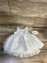 White baby girl dress with pearl accents, tulle skirt, and bow for special occasions