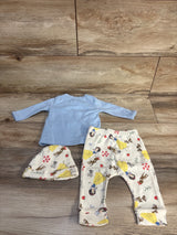 Top view of Disney Baby 3-piece set showing light blue shirt and cream Snow White print pants and hat on wood floor
