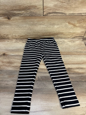 Black and white striped kids leggings on wooden floor