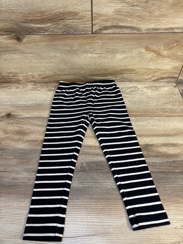 Black and white striped kids leggings on wooden floor