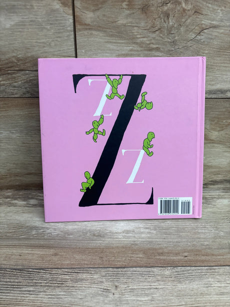 Back cover of Find Your A alphabet letter search hardcover book showcasing a pink cover with black and white Z letters and green figures on a wood surface