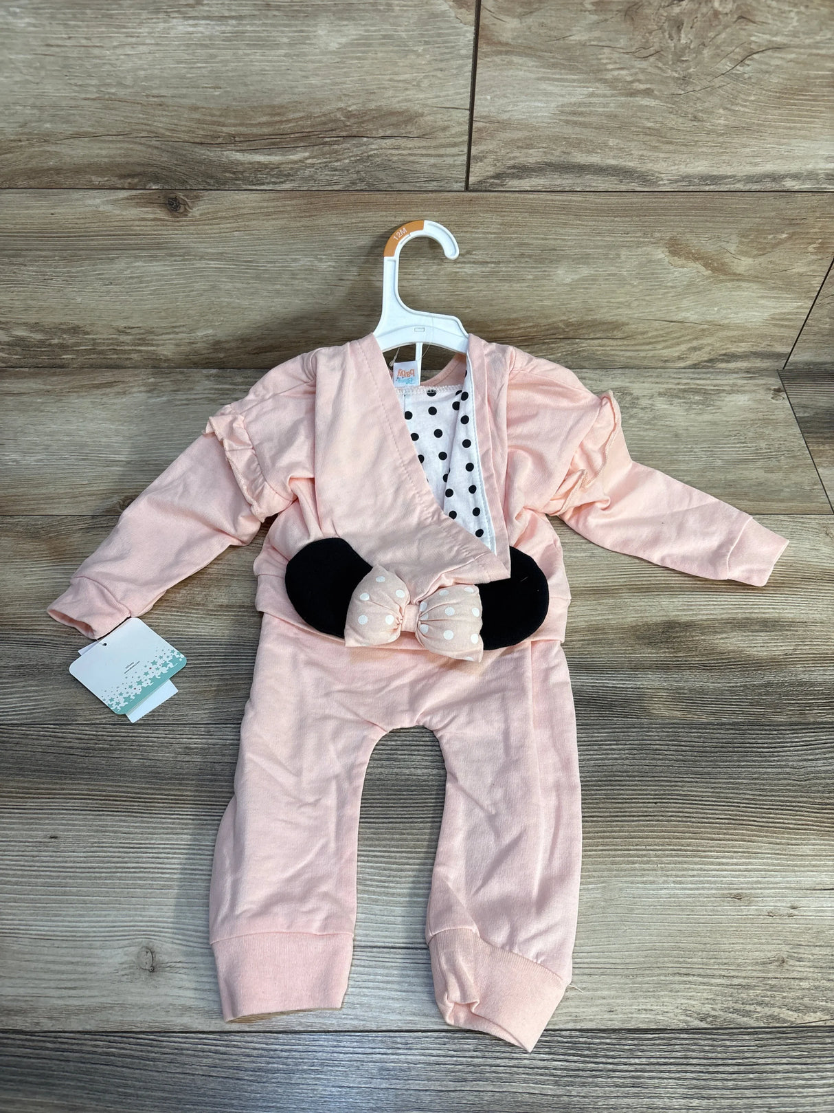 Pink baby girl outfit with polka dot top, ruffle cardigan, and bow pants for 12M