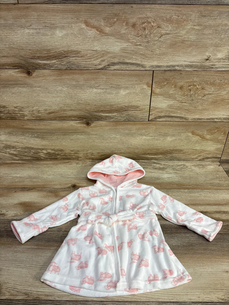 White hooded baby robe with pink animal prints and a belt on wooden floor