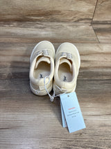 Top view of Cat & Jack toddler slip-on sneakers, off-white size 13C, showing elastic laces and tag on wood background
