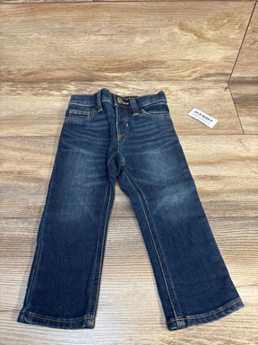 Flat lay of Old Navy toddler jeans, dark wash, size 18-24 months, showcasing straight legs and faded whiskering on wood floor background