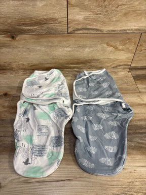 Flat lay of two Aden + Anais newborn (0-3M) swaddle wraps, one white with mint and gray sheep print and one gray with white swirl animal print on wood background