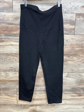 Front view of Alina Mae maternity ankle pant showcasing high-rise foldover band and tapered ankles on wood-plank floor