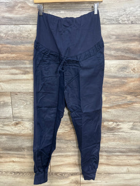 Navy blue maternity pants with elastic waistband and drawstring, displayed on wood background