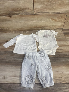 Flat lay of Carter's 3-piece ivory baby bodysuit set with elephant prints on top, bodysuit, and gray pants on wood floor