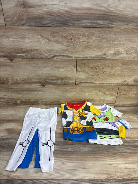 Flat lay of Toy Story 4-piece pajama set (2T) showing Woody and Buzz printed tops with white and blue pants on wood floor
