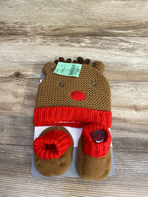 Brown and red knitted baby reindeer hat with matching booties on wooden surface