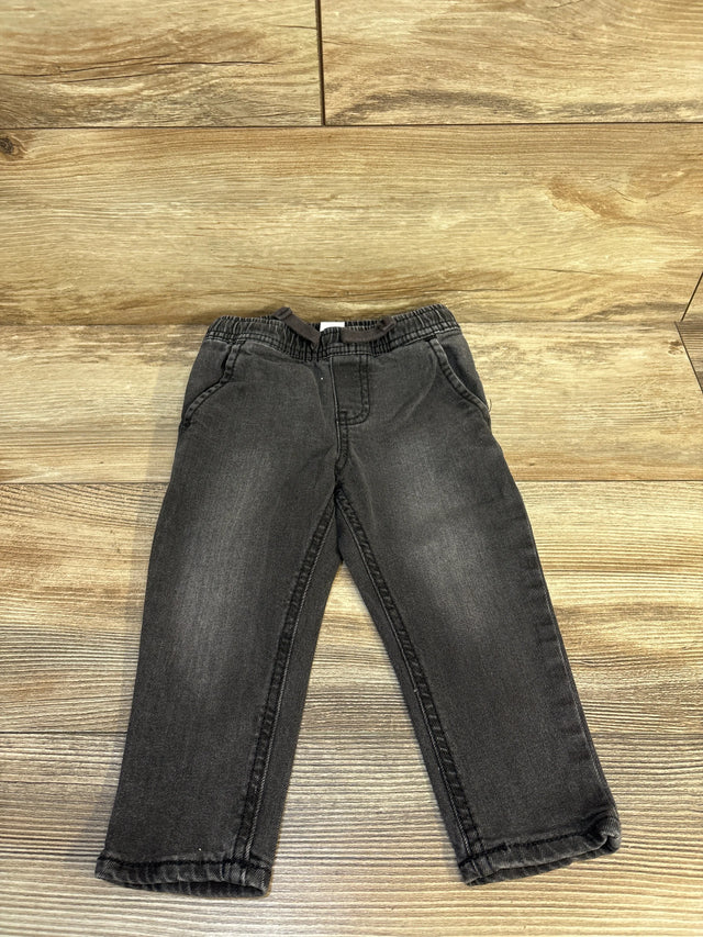 Black toddler jeans with elastic waistband on wood floor, kids' resale clothing