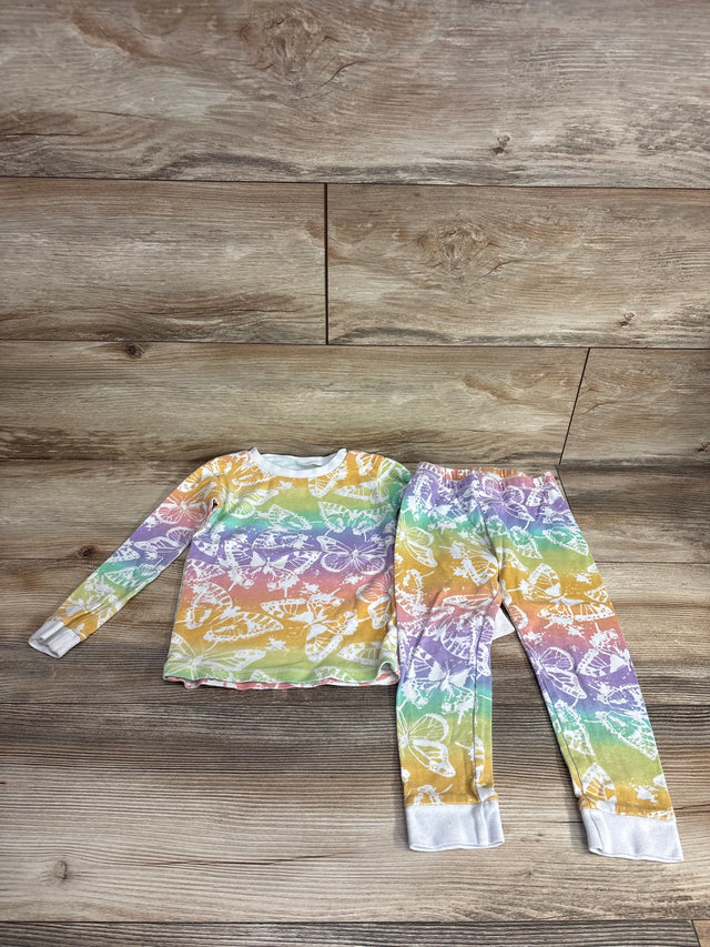 Children's long sleeve pajama set with rainbow colors and white butterfly patterns on wooden floor