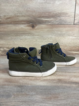 Olive green toddler high-top sneakers with navy laces on wood background