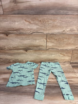 Flat lay of sage Just One You 2pc ribbed toddler pajama set showing ribbed texture and navy alligator print on wood