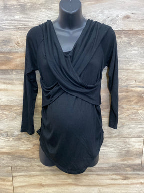 Black long sleeve maternity top with draped front on mannequin, wood background