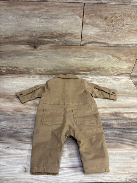 Back view of Carter’s brown canvas coverall in size 3 months showcasing long sleeves and two rear pockets on a wood floor