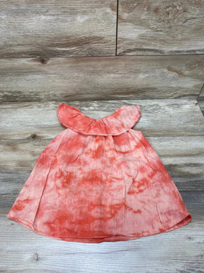 Flat lay of Splendid tie-dye toddler dress with coral-pink ruffle neckline, A-line shape, size 18-24 months on wood background