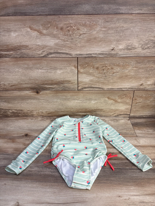 Front view of green girls' long-sleeve rash guard with white stripes and small strawberry print on white background