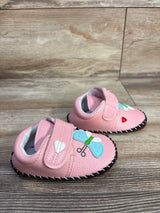 Three-quarter view of pink PU leather baby sneakers size 3C with black stitched sole, velcro strap, butterfly, heart appliques