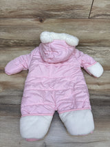 Front view of pink Wippette bear puffer bunting showcasing quilted padding, hood, and white covered hands and feet on wood flooring