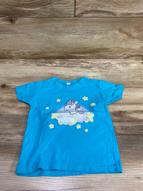 Front view of blue unicorn shirt in size 2T showcasing a unicorn on a cloud with stars against a wood background