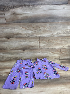 Purple toddler pajama set with Minnie Mouse print featuring pants and long-sleeve button-up top on wood floor