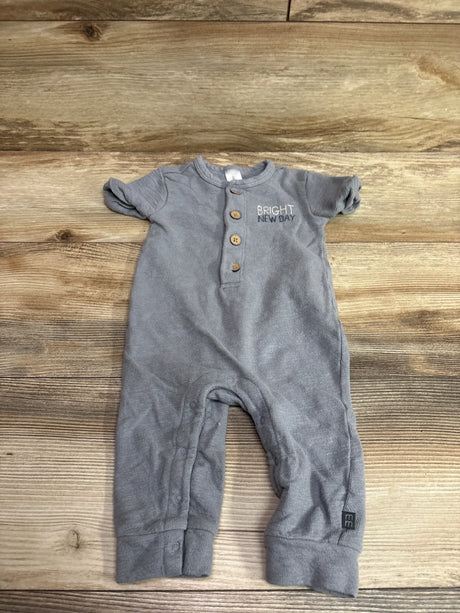 Front view of gray Modern Moments Henley jumpsuit showcasing button placket and rolled cuffs on a wood-grain background
