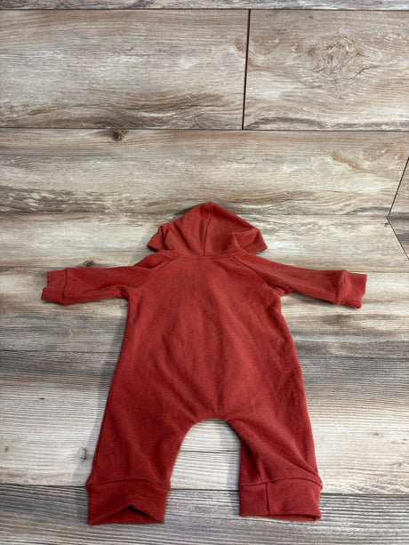 rust orange hooded baby fleece romper laid flat on wood textured background