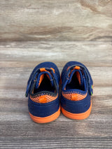 Back view of Stride Rite Phibian water sneakers, navy with orange trim, showing heel pull tabs on wooden floor