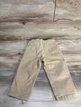 Back view of Baby Gap slim chino pants in khaki, size 2T, showing elasticized waist and back welt pockets on wood floor