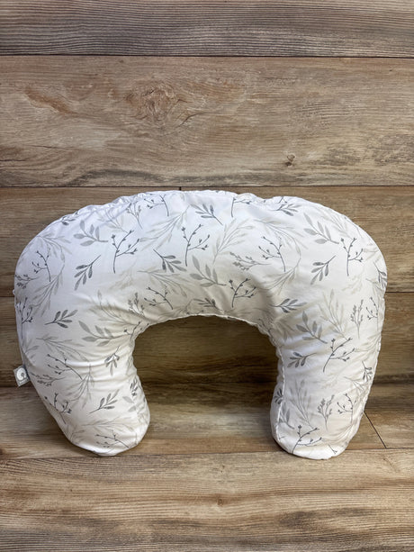 Top view of Boppy nursing pillow showcasing botanical leaf slipcover on a wood surface