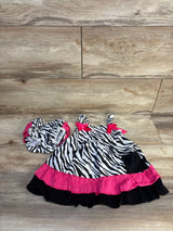 Zebra print baby dress with pink ruffle trim and matching diaper cover on wood floor