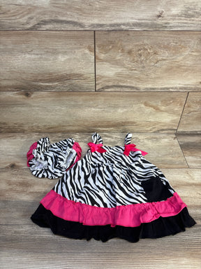 Zebra print baby dress with pink ruffle trim and matching diaper cover on wood floor
