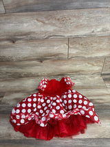 Red toddler dress with white polka dots and tulle underskirt on wooden floor