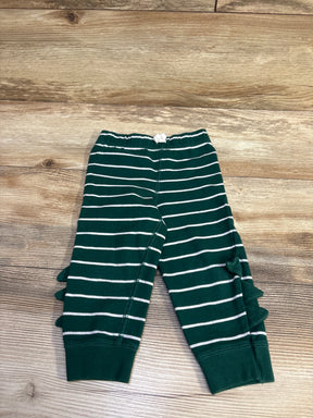 Flat lay of Carter’s green striped baby joggers size 18M showing side ruffles, elastic knot waistband and ribbed cuffs on wood