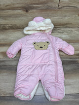 Front view of pink Wippette bear puffer bunting with bear ear hood and front pocket on wood floor