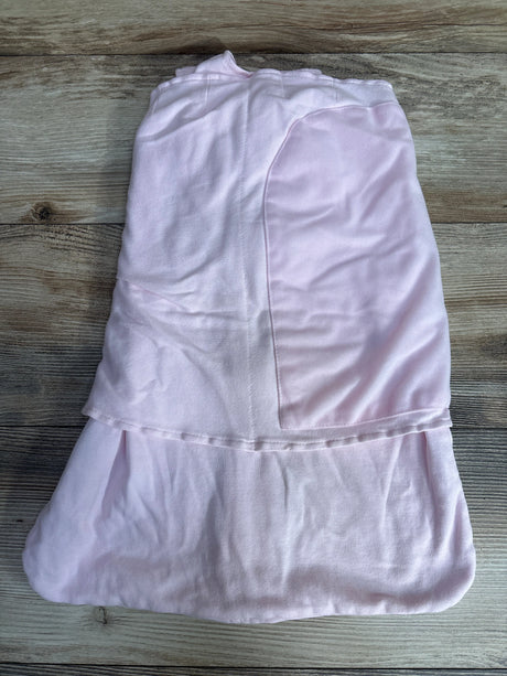 Pink baby swaddle blanket folded on wooden floor, soft fabric with stitched panel
