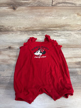 Front view of red Disney Baby shortie romper with Minnie Mouse print, ruffled shoulder straps, snap crotch laid flat on wood background