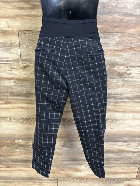 Back view of Old Navy Pixie maternity pants, black windowpane, full-panel belly band and welt pockets on wood background