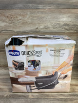 Front of boxed Chicco QuickSeat hook-on chair in teal showing product image and 'Makes mealtime a cinch' headline on torn box